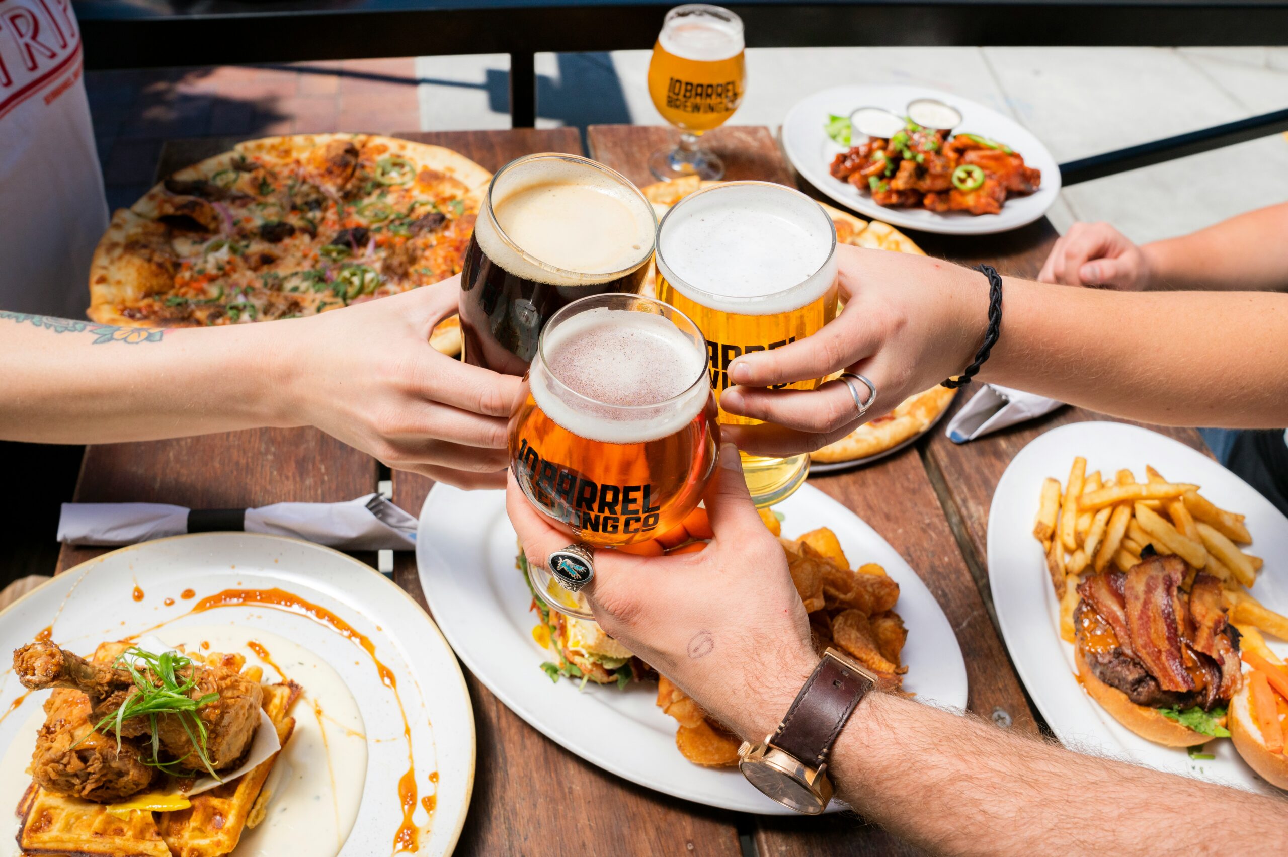 people enjoying a meal and drinking beer